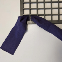 Photo of a strip of fabric being fed through the rubber mat