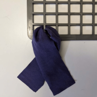 Photo of a strip of fabric fed through the rubber mat and being tied