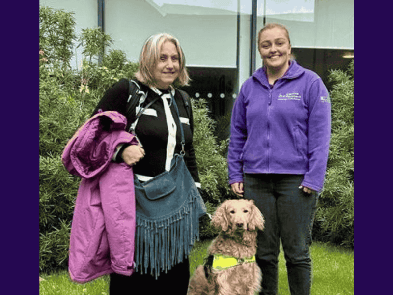 Photo of trainer and lady with dog in the middle of them