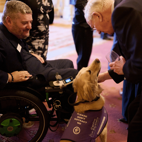 The Duke of Gloucester meeting a Canine Partners partner and their assistance dog at the Windsor Castle event